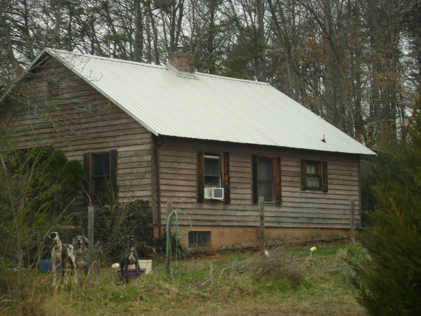 White metal roof on an old wood sided farmhouse, from a Metal Roof Installation job in Corning